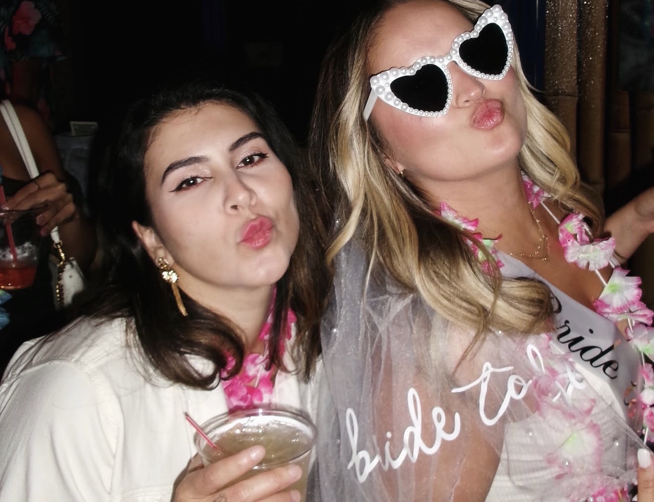 Layza in heart-shaped glasses blowing a kiss with a friend