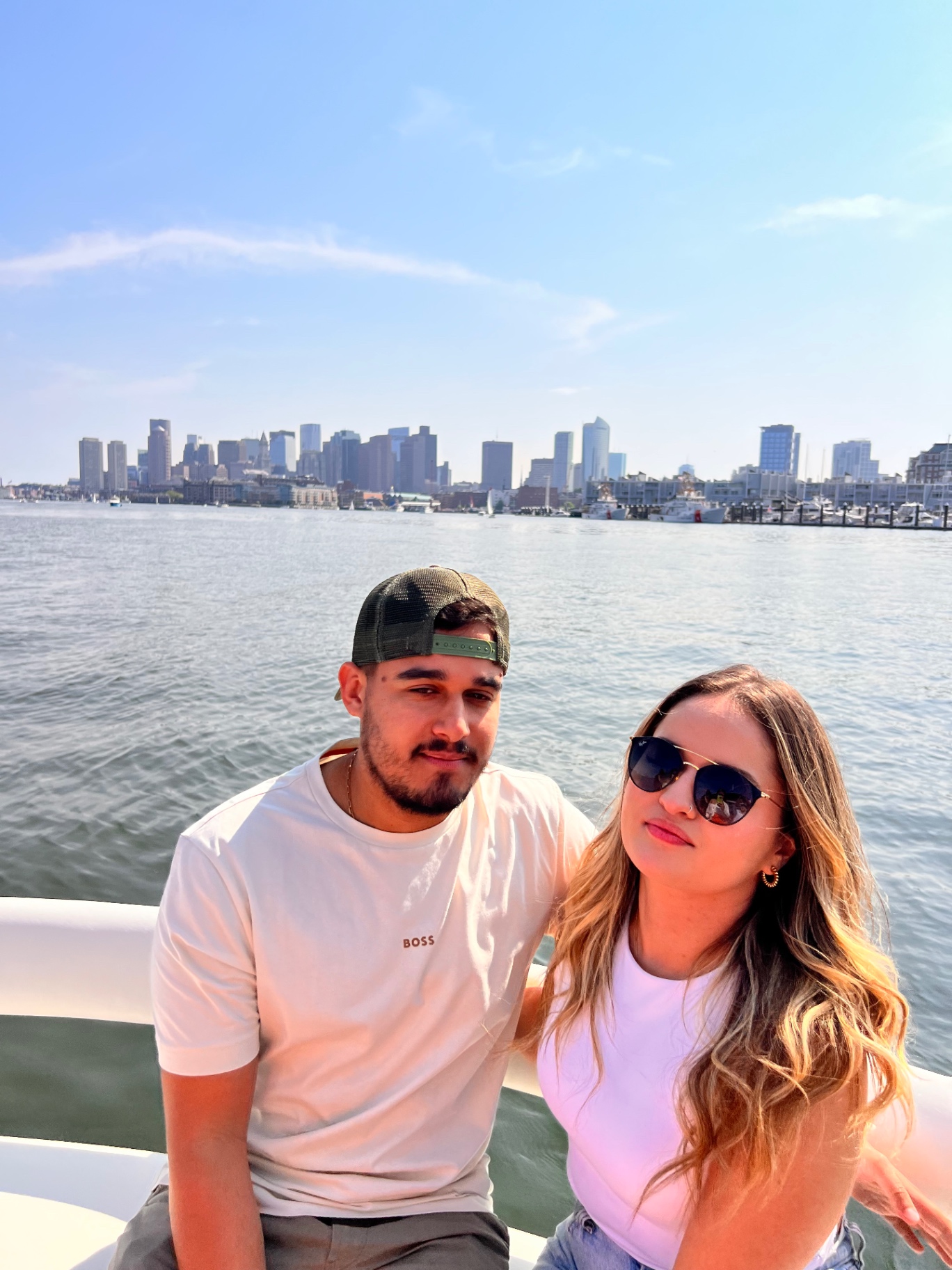 Matheus and Layza on the boat with the Boston skyline behind them