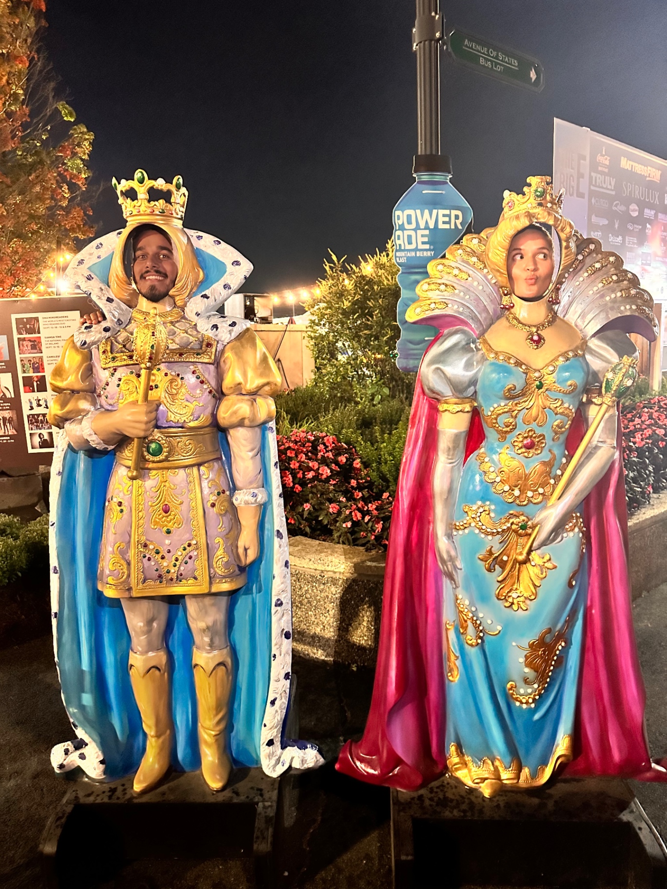 The couple posing as a king and queen cutout at the fair